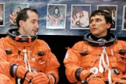 "I dunno, Philippe, what do YOU wanna do?" Astronauts Perrin and Chang-Diaz are pictured here during preflight training in Houston. They are wearing their orange Launch and Entry suits, not the Extravehicular Mobility Units (white spacesuits) they'll be sporting during their spacewalks. NASA photo.