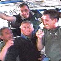Soon after their arrival at the International Space Station, (bottom left to right) Expedition Five Commander Valery Korzun, STS-111 Commander Ken Cockrell and Expedition Five Flight Engineer Sergei Treschev and (top) STS-111 Mission Specialist Philippe Perrin talk to the Mission Control Center in Moscow. NASA image.